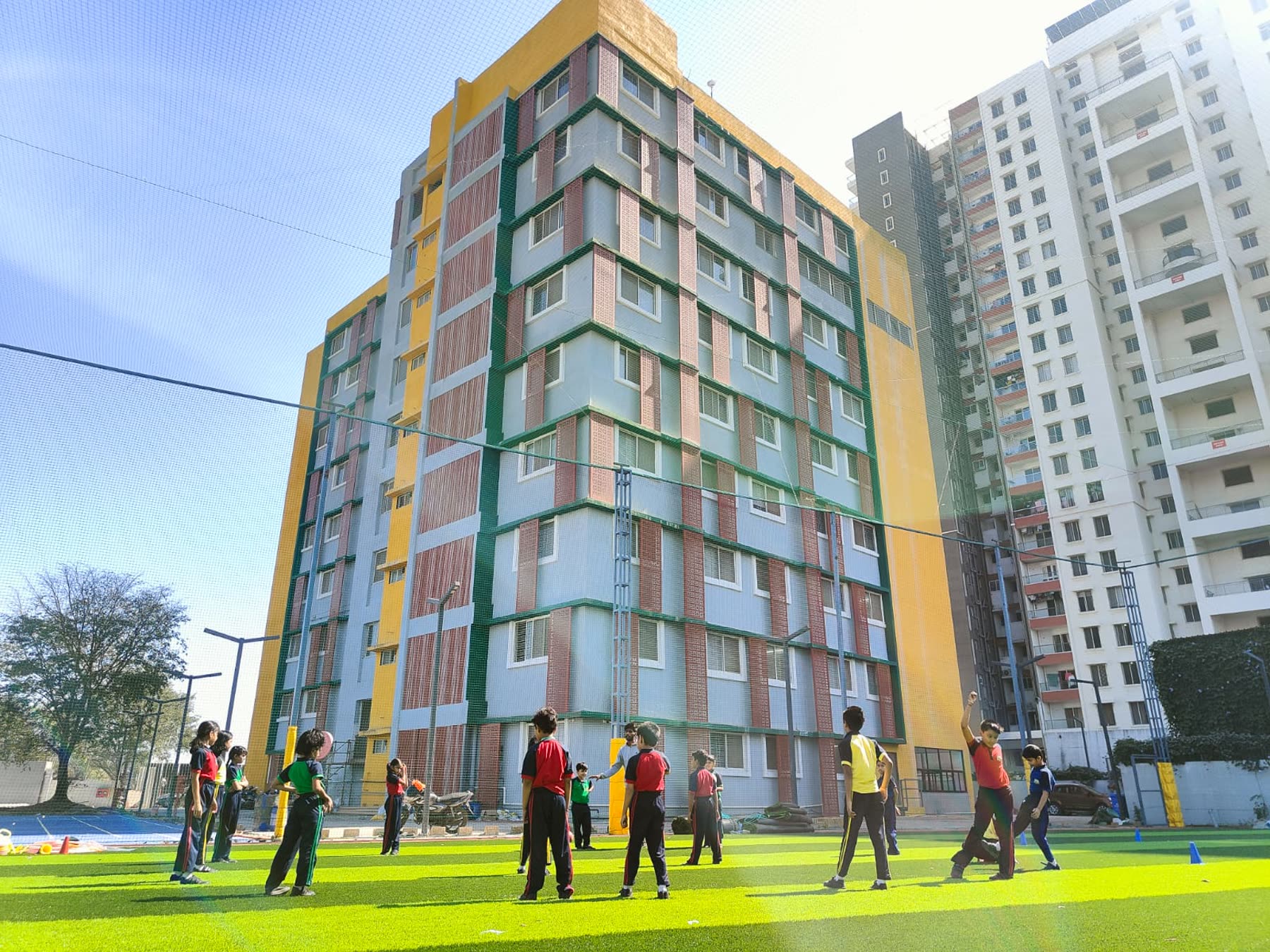 MIS School Hinjawadi campus building beside the sports turf
